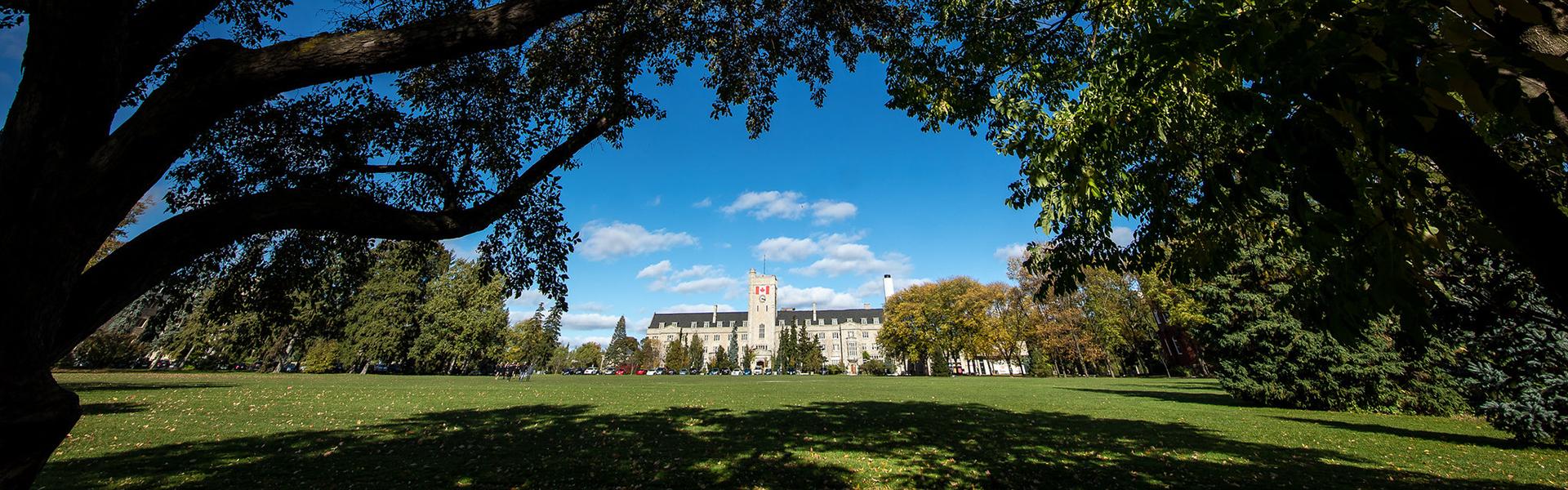 Johnston Hall in the distance, framed by trees in the foreground