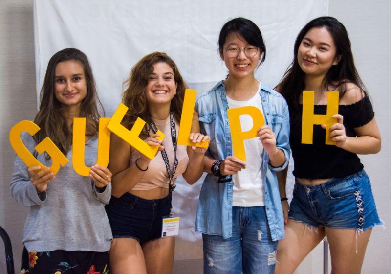 Students holding up letters that spell Guelph.