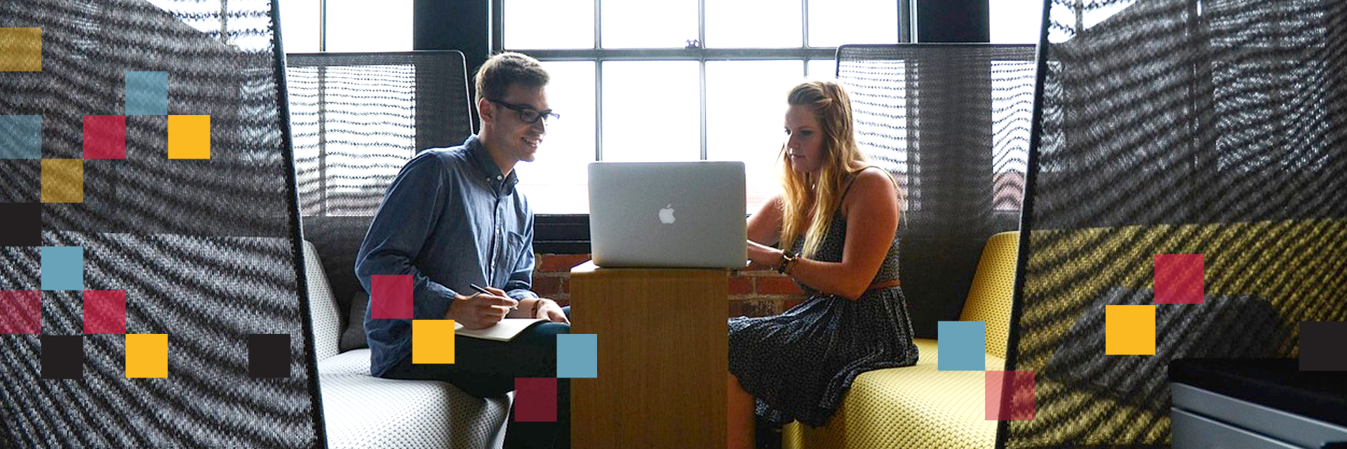 two entrepreneurs looking at a computer together