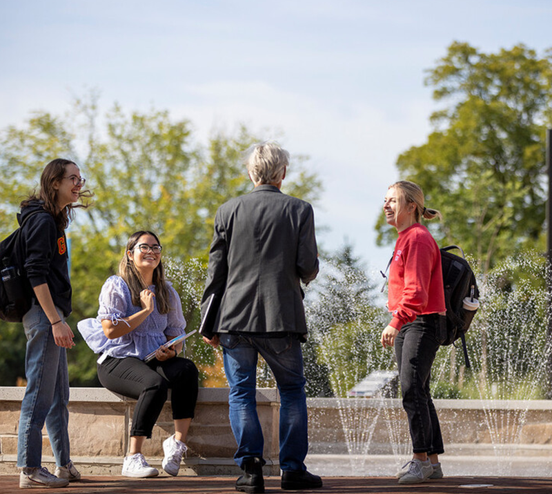 students and faculty talking