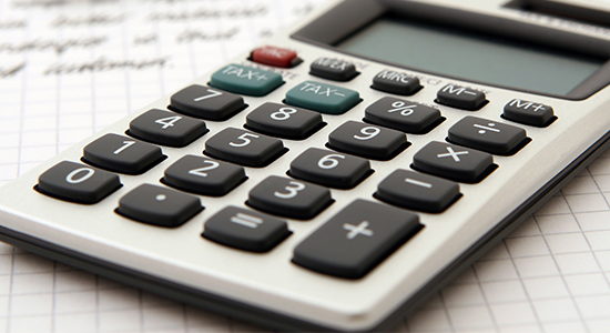 Calculator on top of a notepad with writing