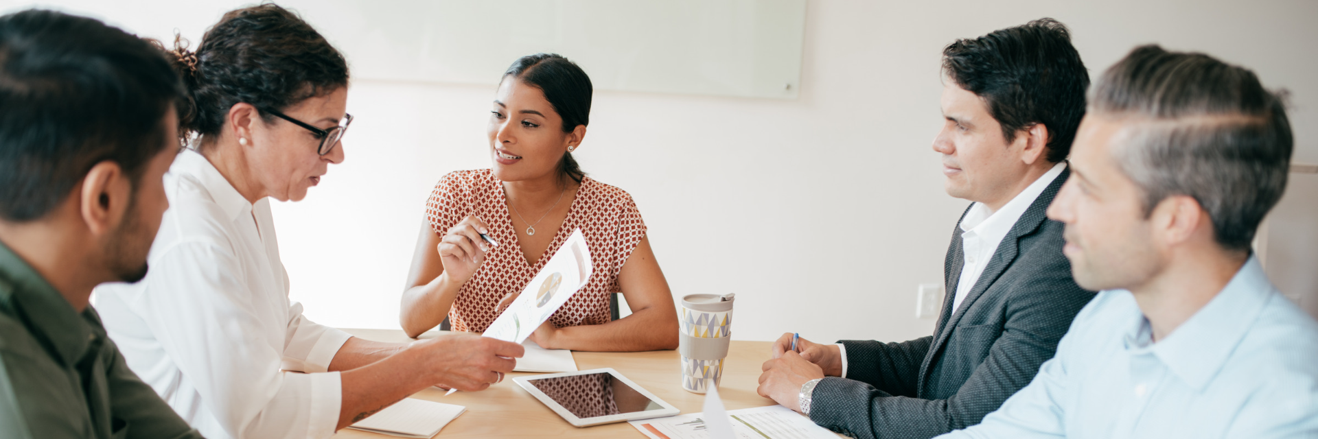 Five people around a table.