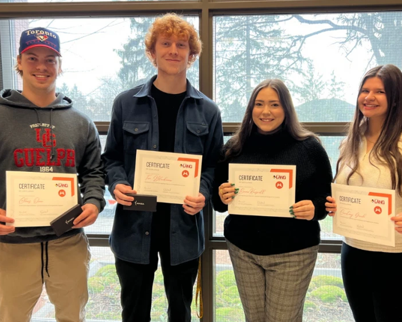 students holding a certificate