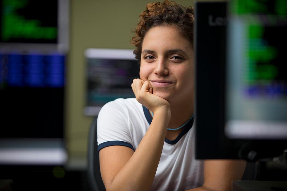 A woman sits in a computer lab