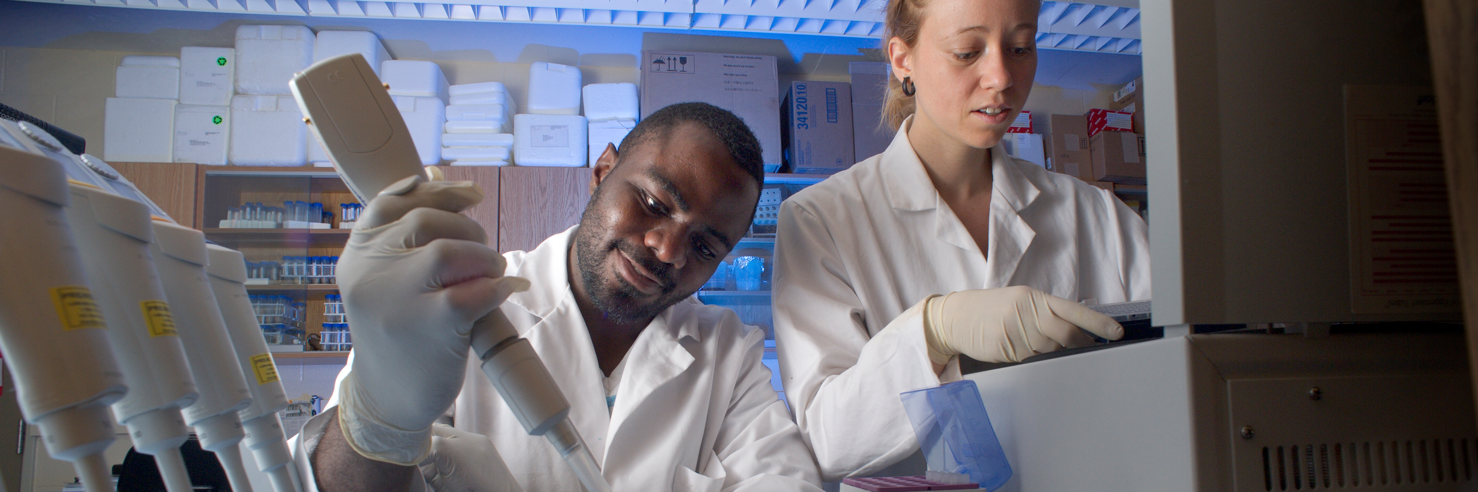 graduate students in a laboratory, analyzing a specimen