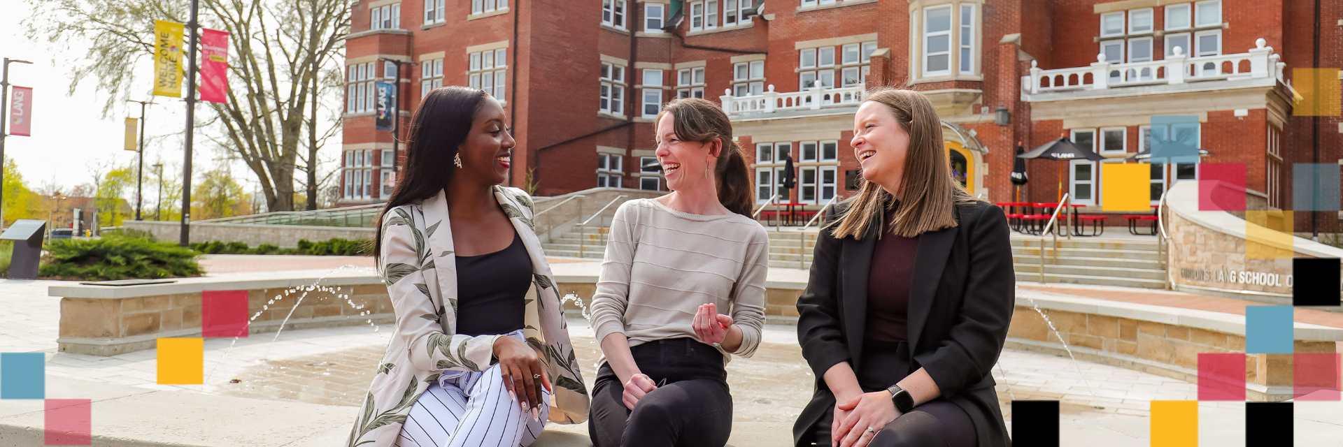 Three people sitting at the fountain in Lang Plaza.