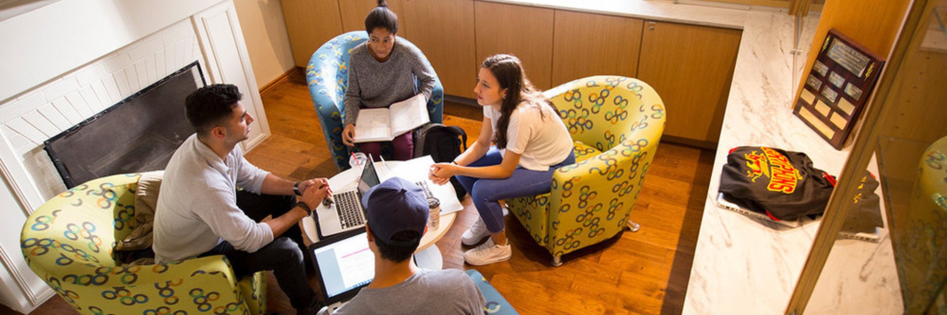 Four people in the Heritage Room working and talking.