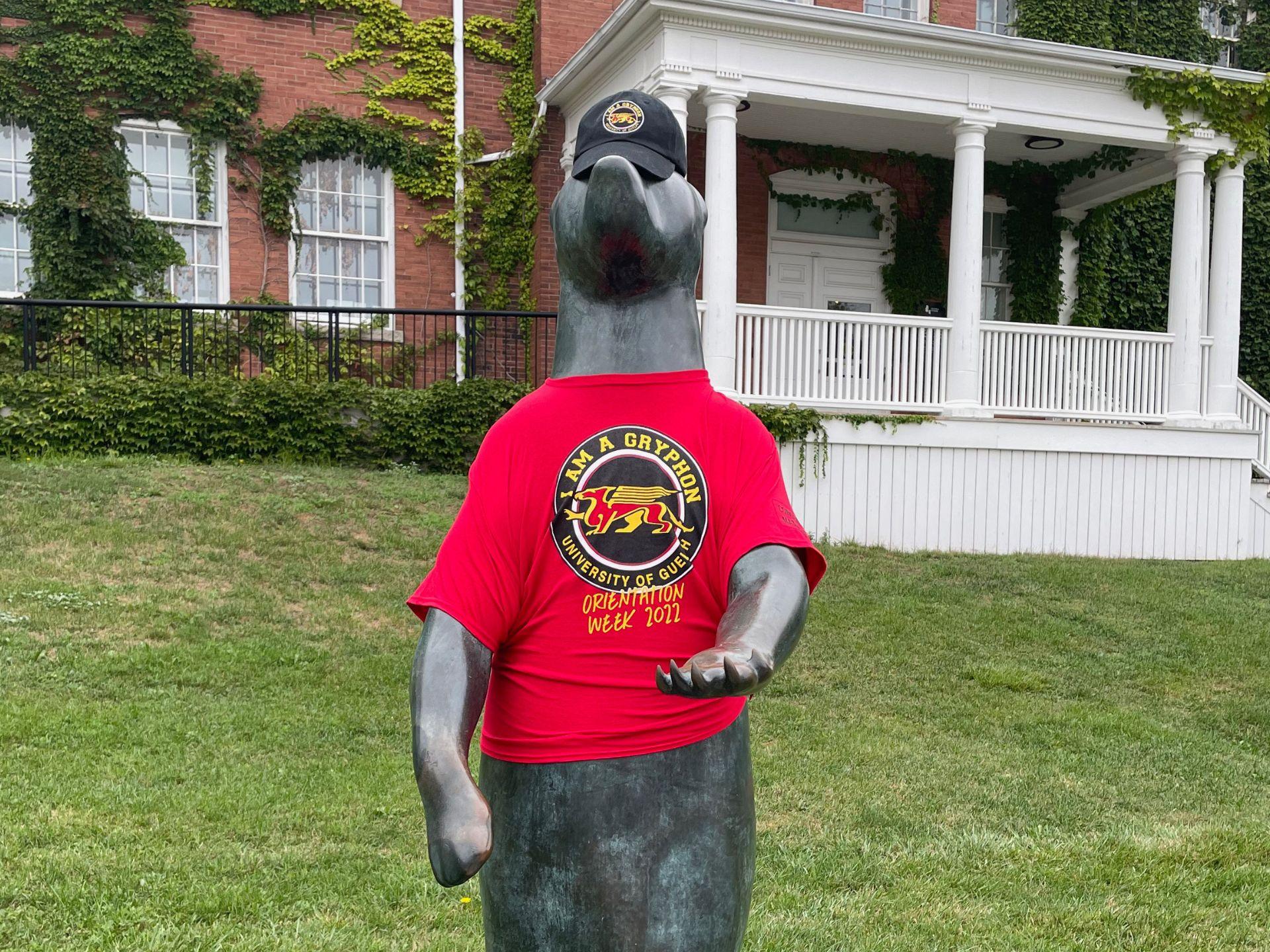 The Begging Bear wearing a red Orientation Volunteer shirt