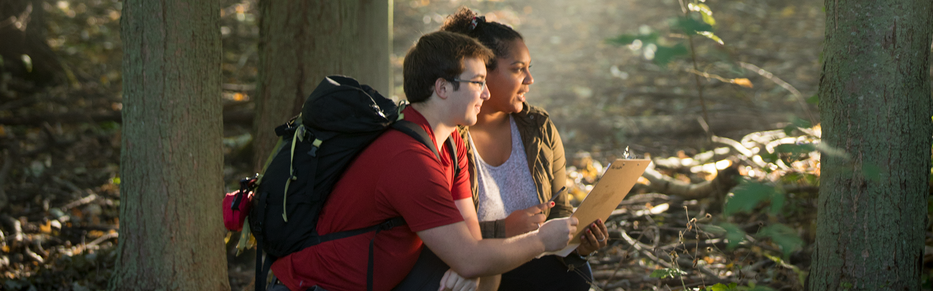 two students exploring a forest