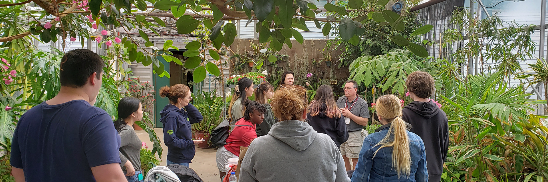 students in a greenroom listening to a professor
