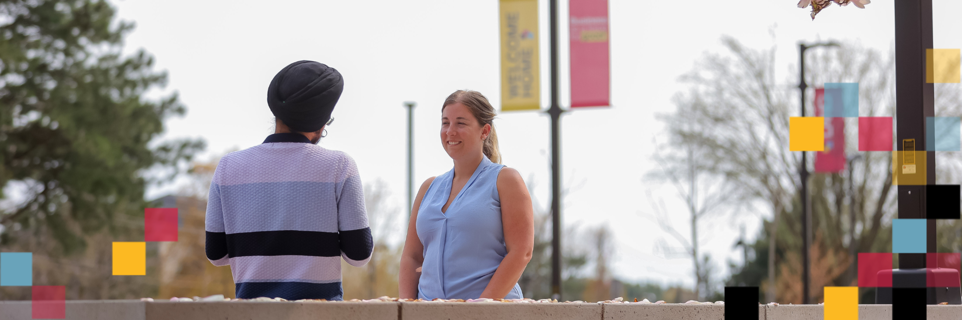 Two people talking in Lang plaza.
