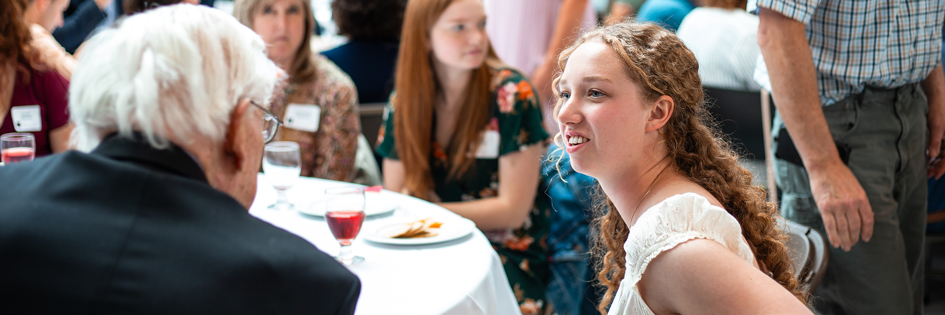 a student talking to an elderly donor at an event