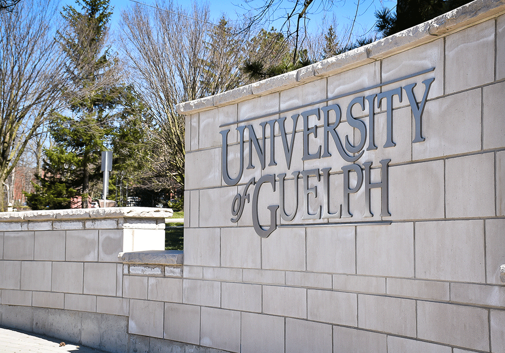 Outdoor wall with University of Guelph logo on it.