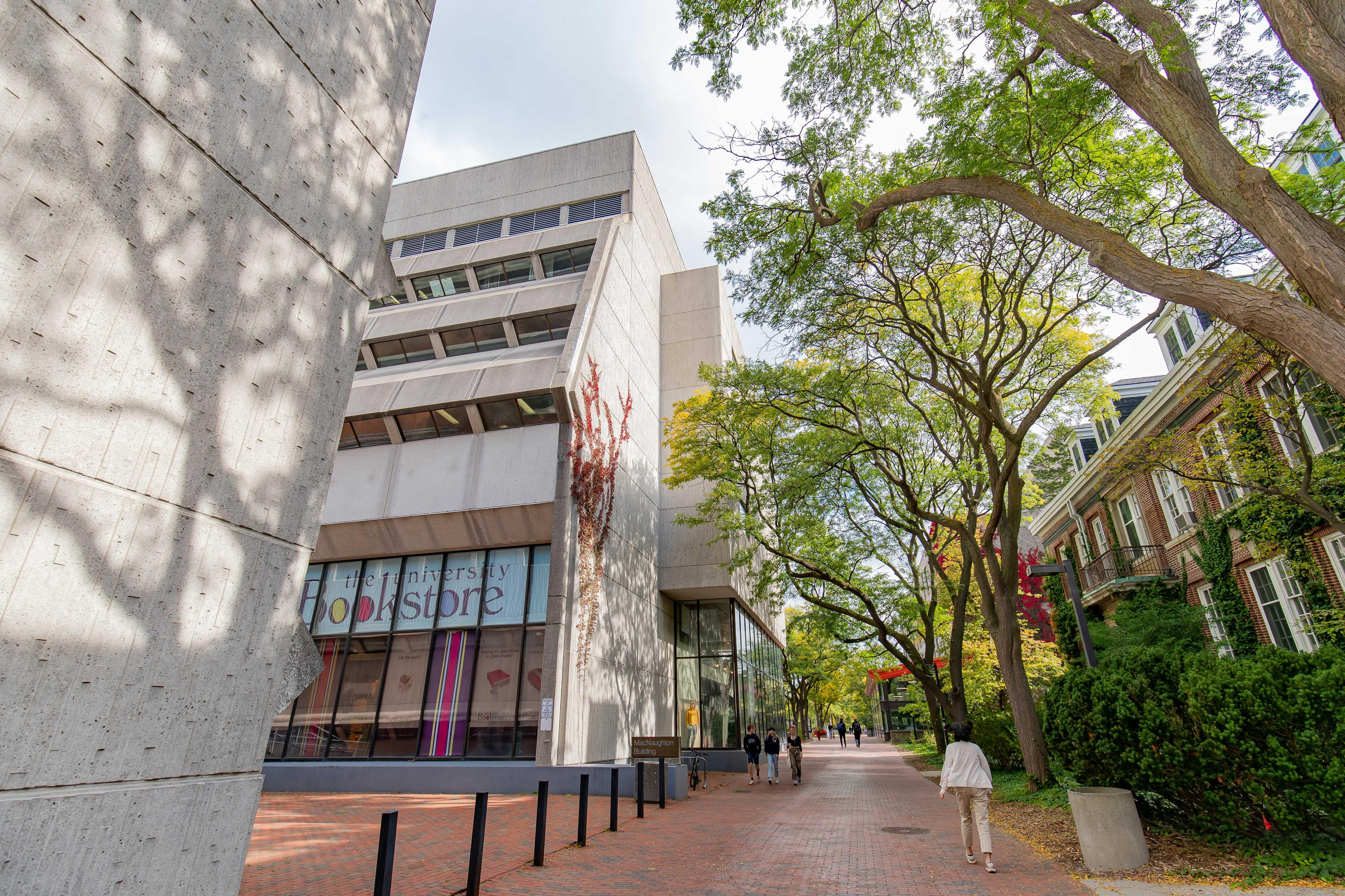 Image of the back of UofG bookstore and red brick pathway on campus.