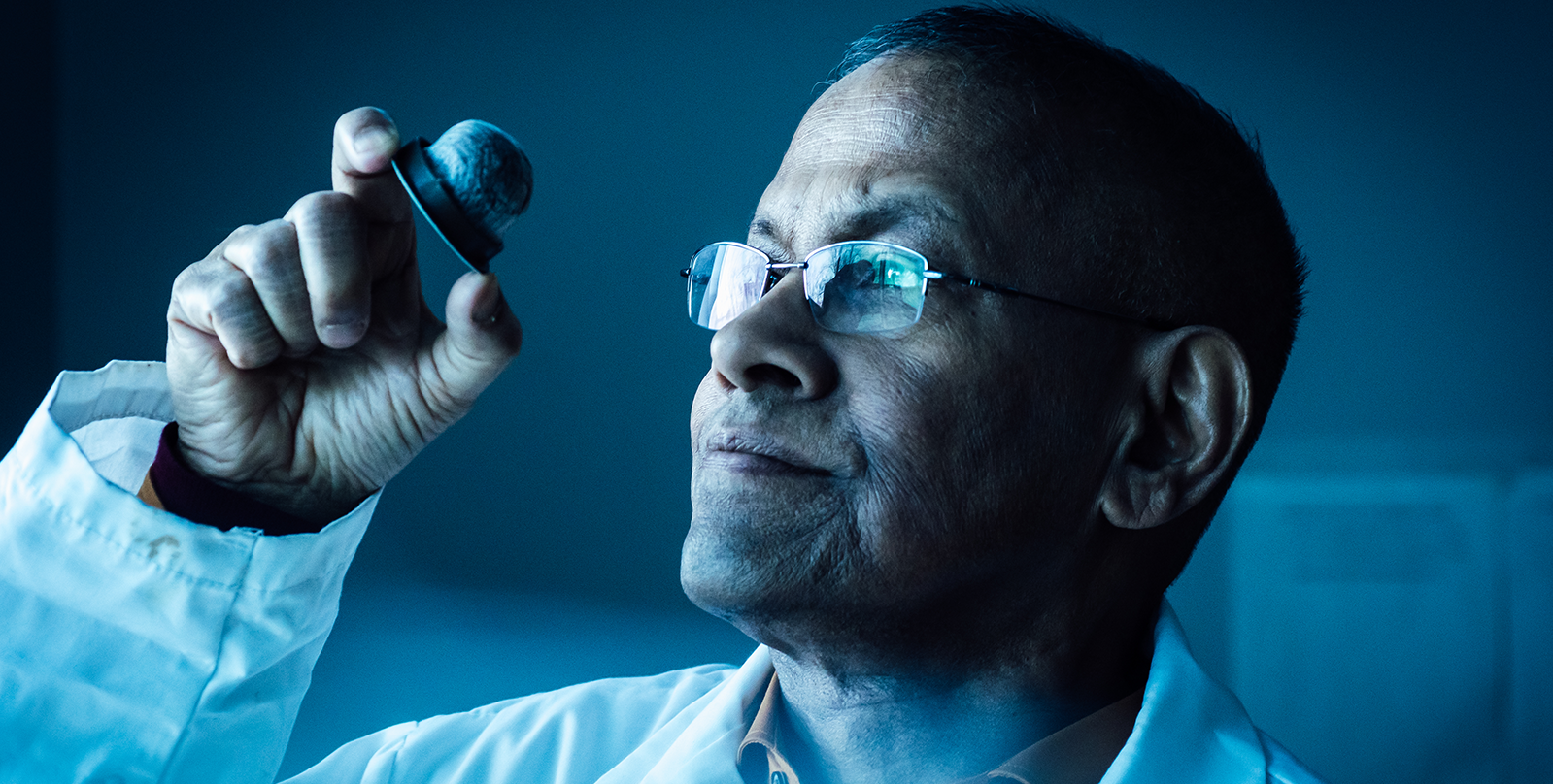 faculty member holding an coffee pod in their hand