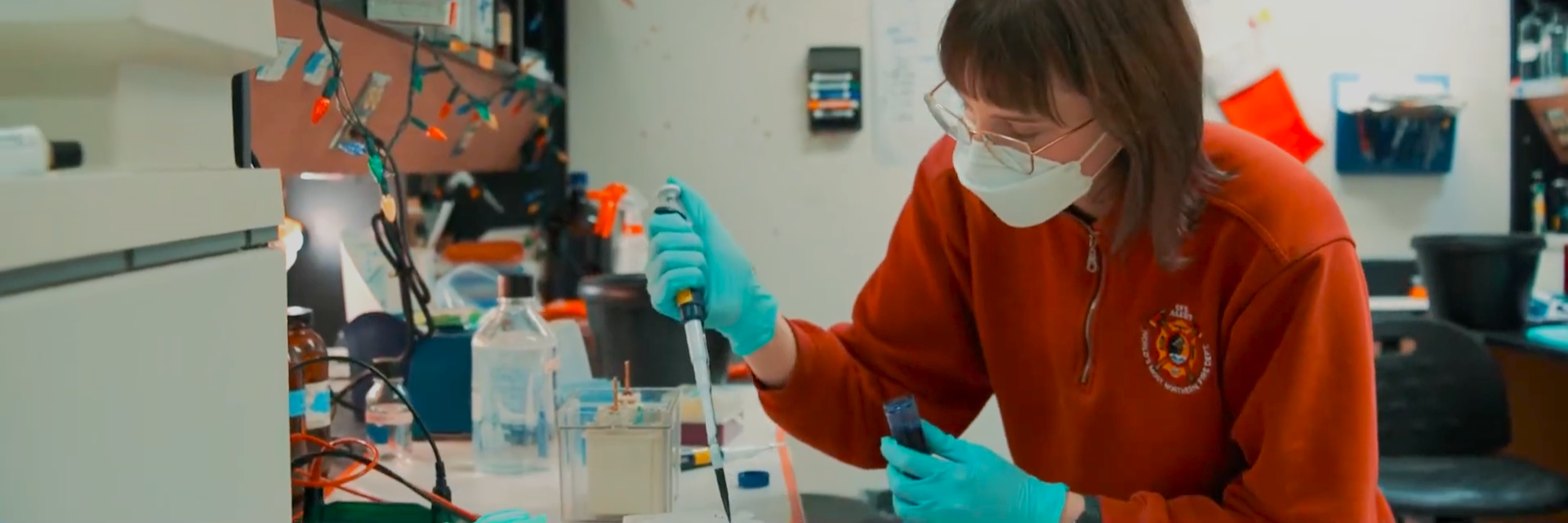 a person uses a pipette in a lab