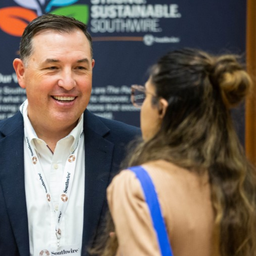 an employer chatting with a student at an event