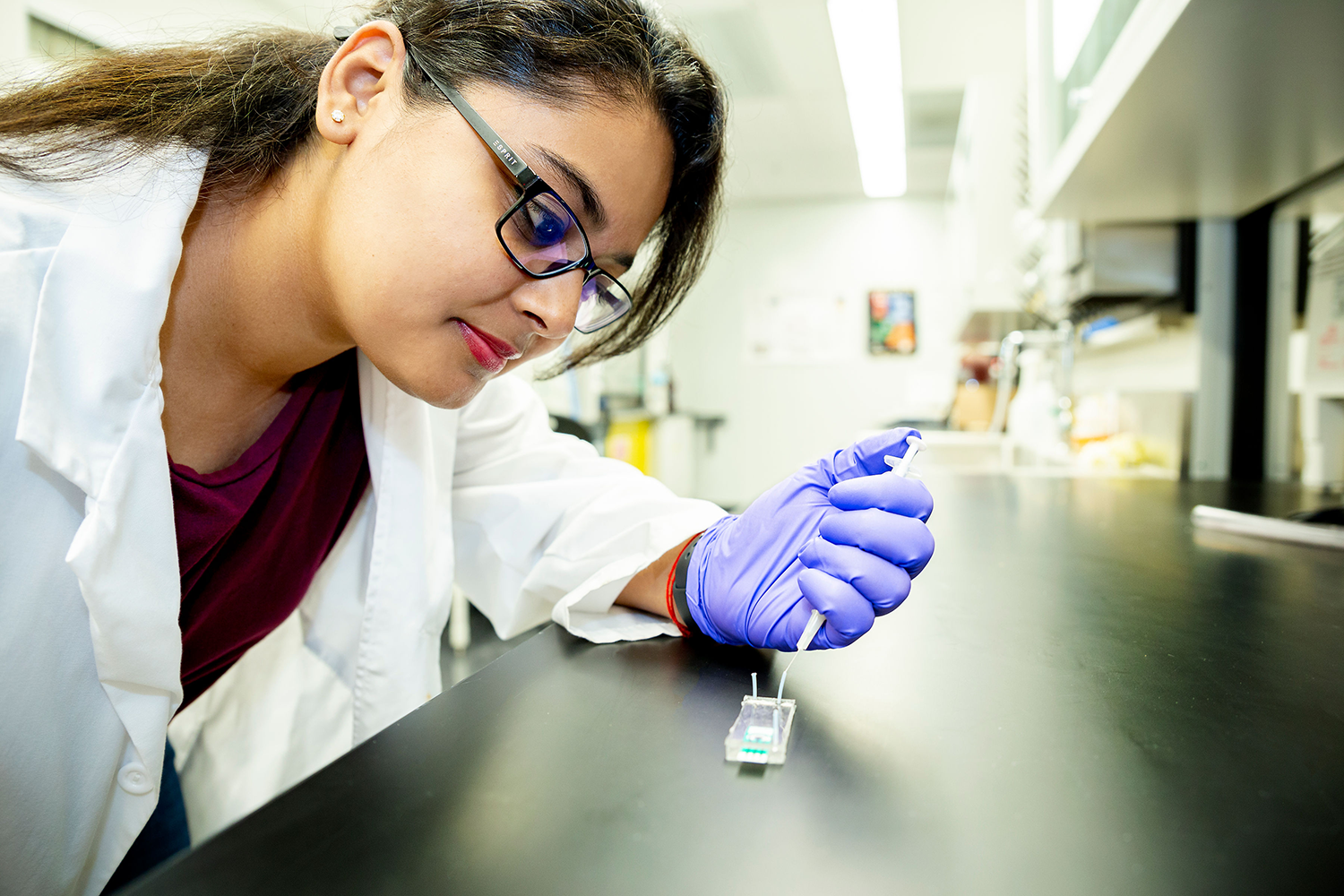 Engineering graduate student using a syringe