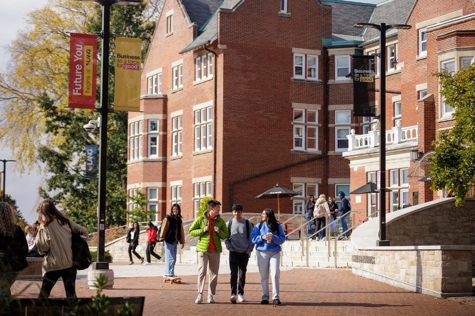 international students outside a red brick building