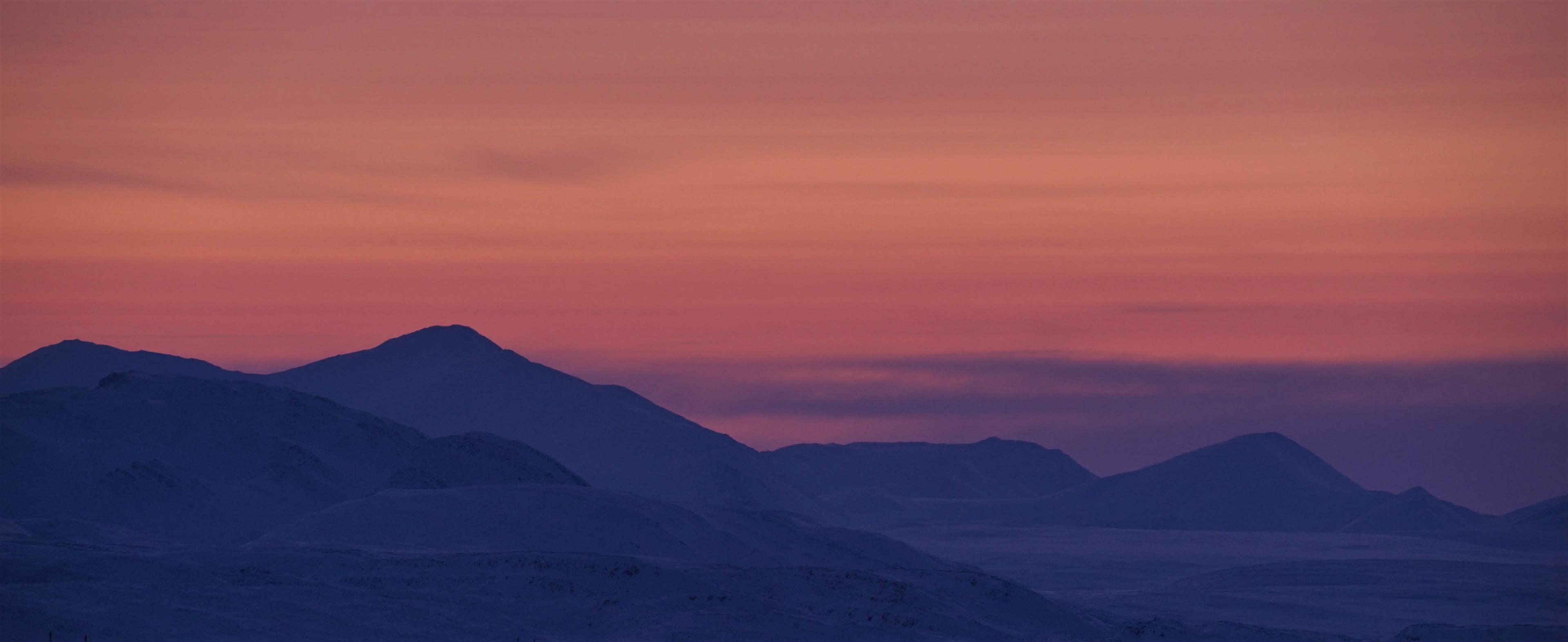 A pink and purple sunset over the icy landscape