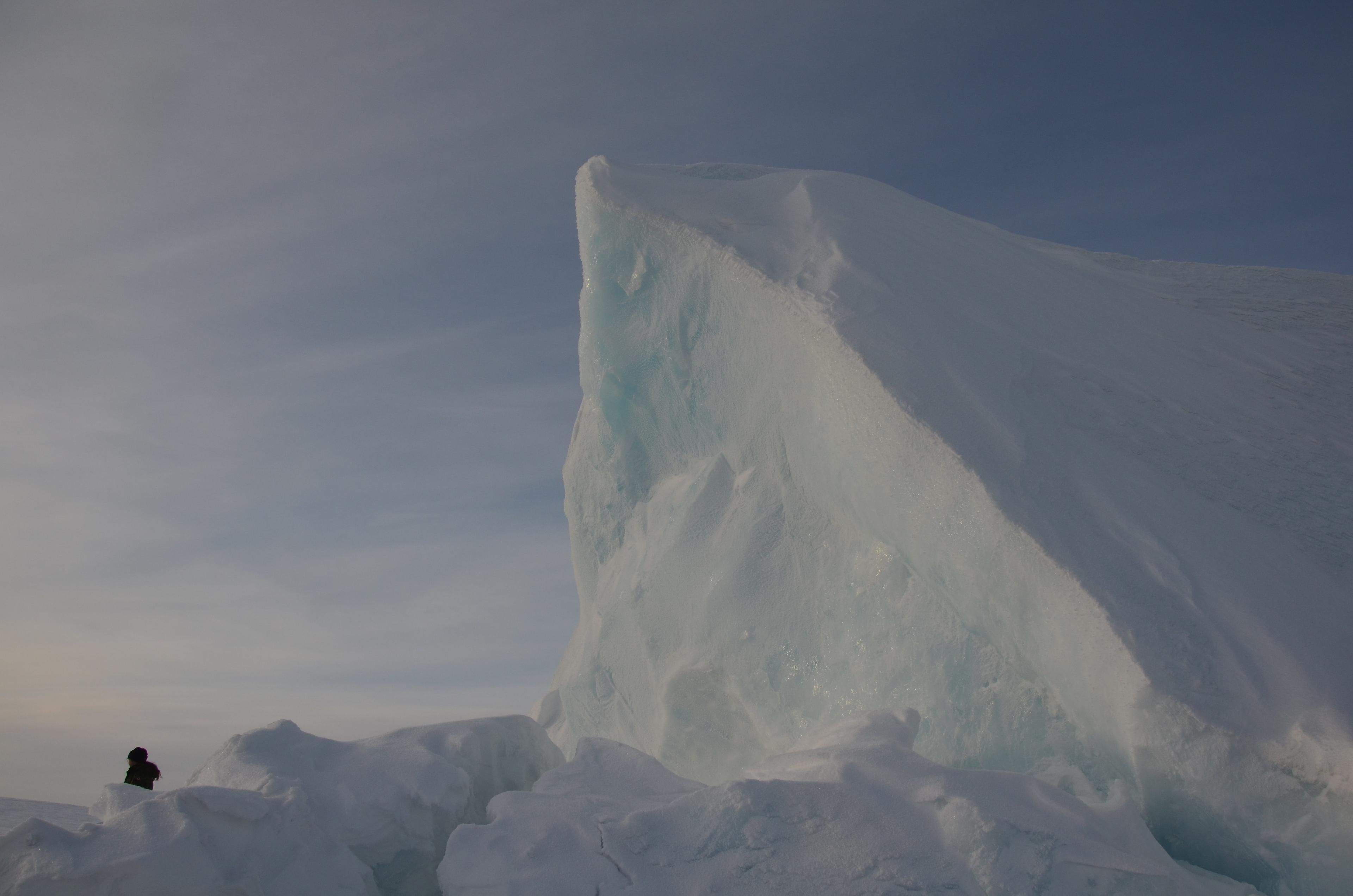 Mitchell next to a massive sheer ice cliff
