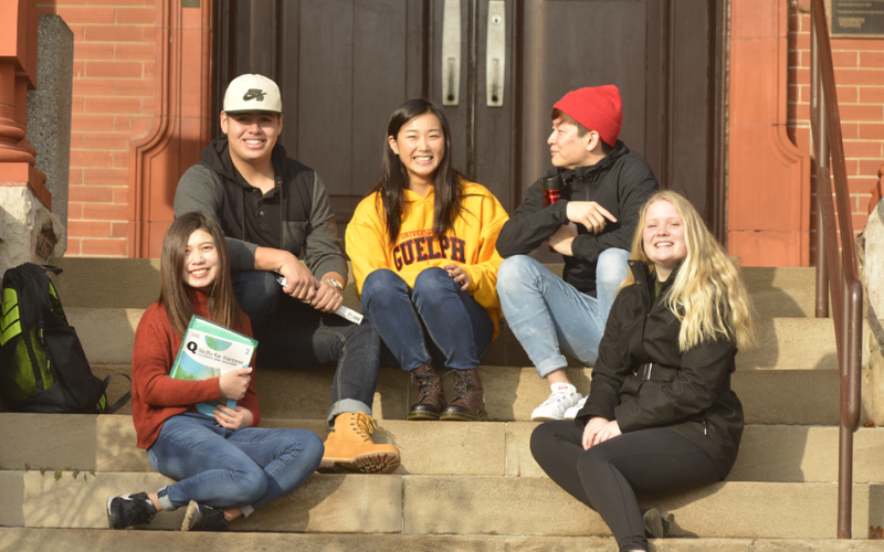 U of G students sitting on steps