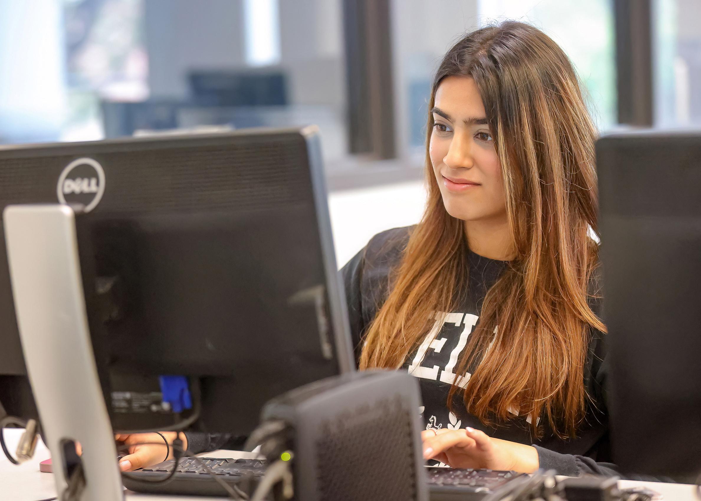 A student works on a computer at U of Guelph