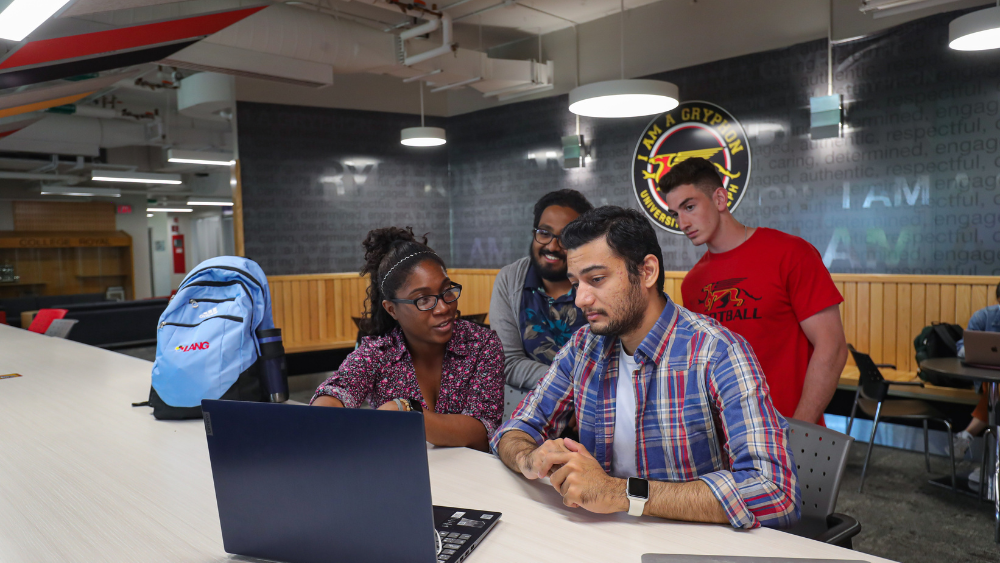 Four students in the UC around a computer.