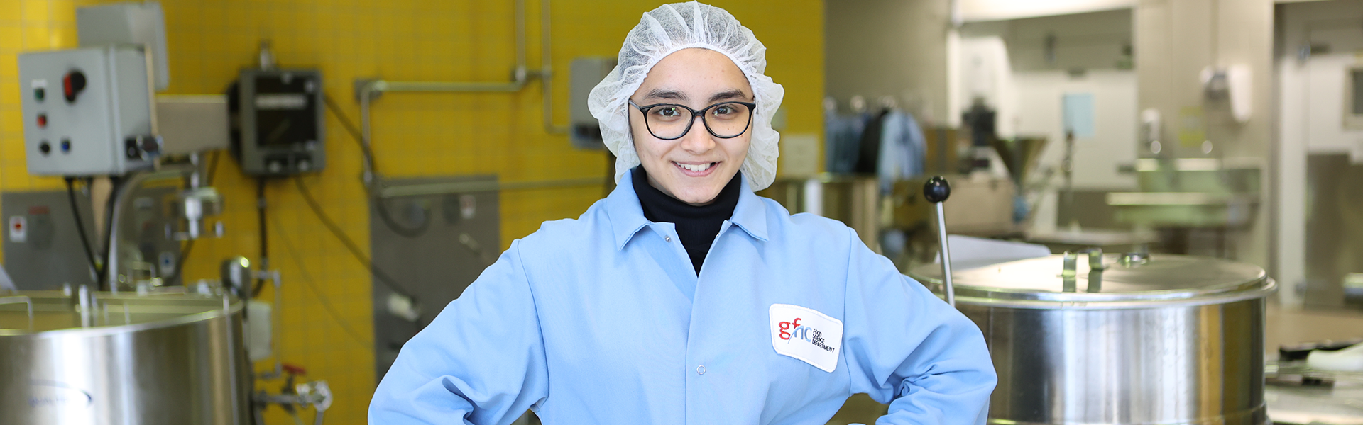 a student in a food lab standing with her hands on her hips