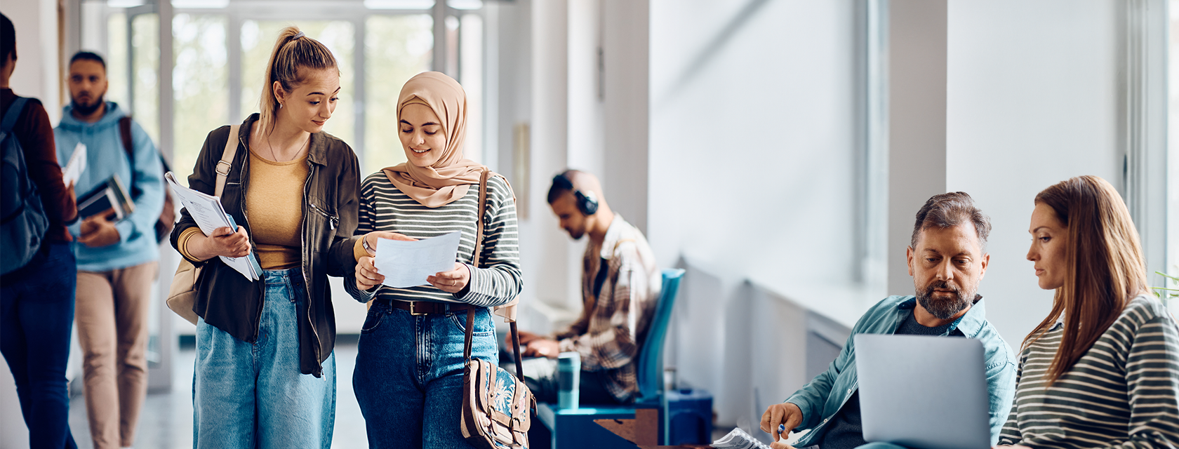 Students chat in the hallway and compare class notes