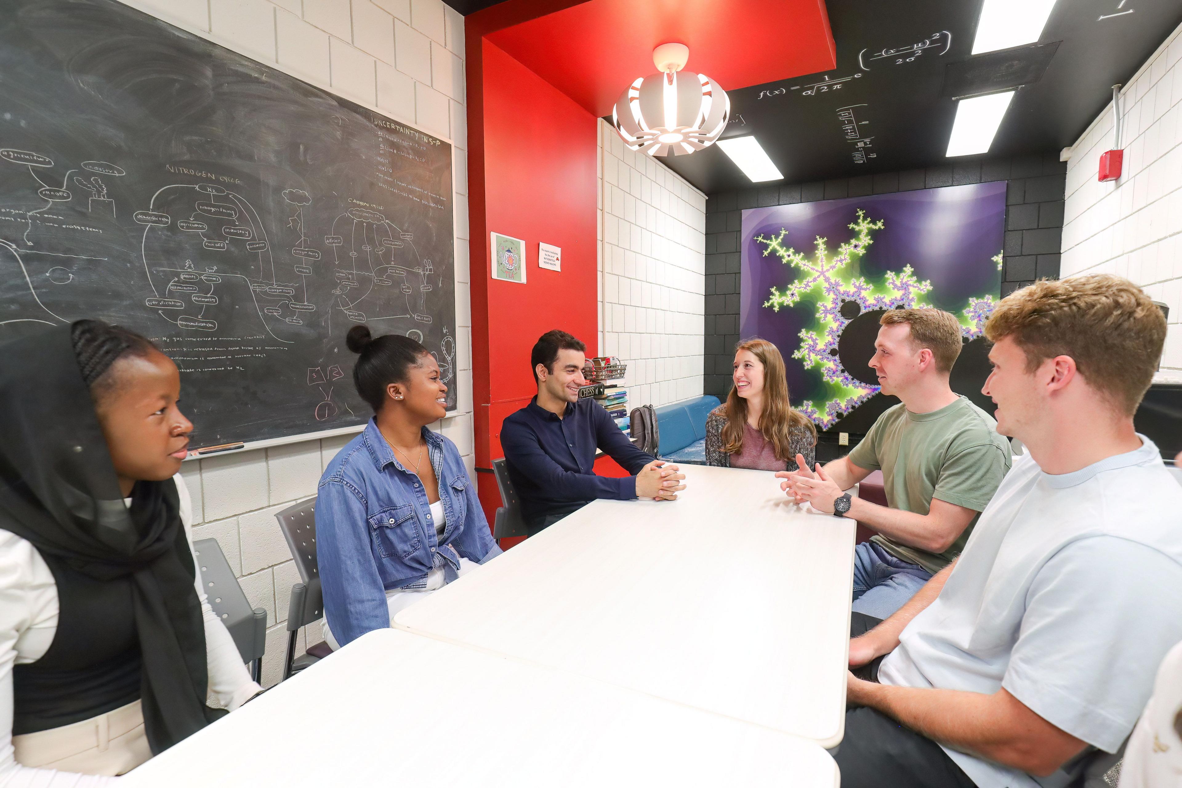 People sitting around table in discussion