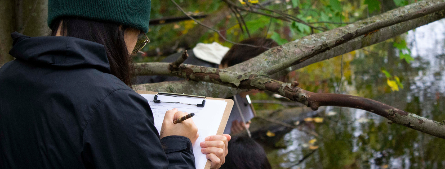 A student writing notes while researching