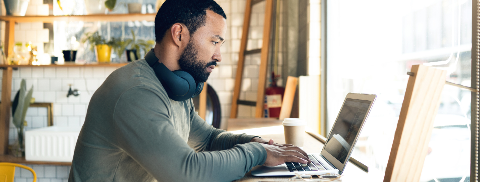 A student typing on a laptop at a desk