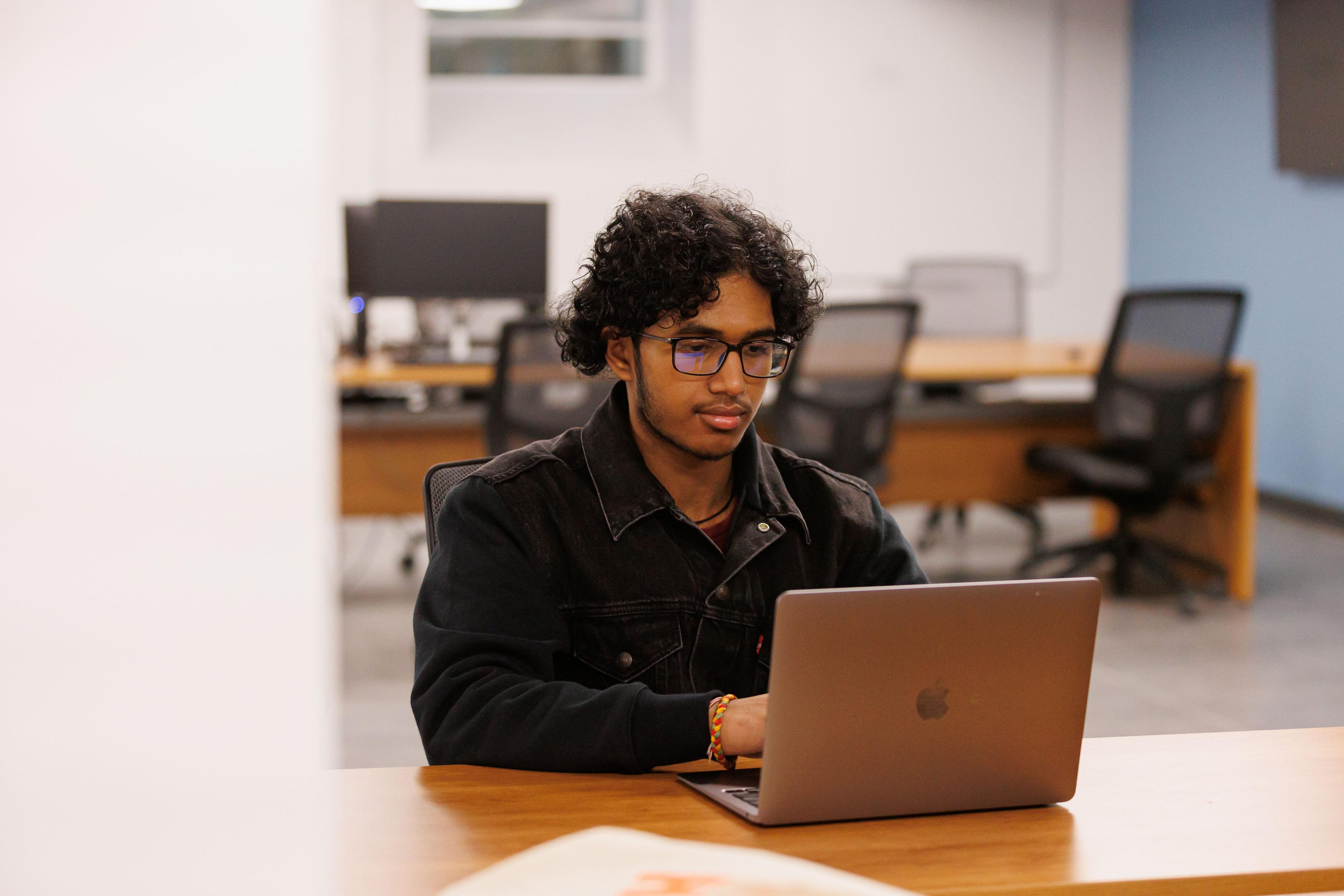Student using laptop at a desk
