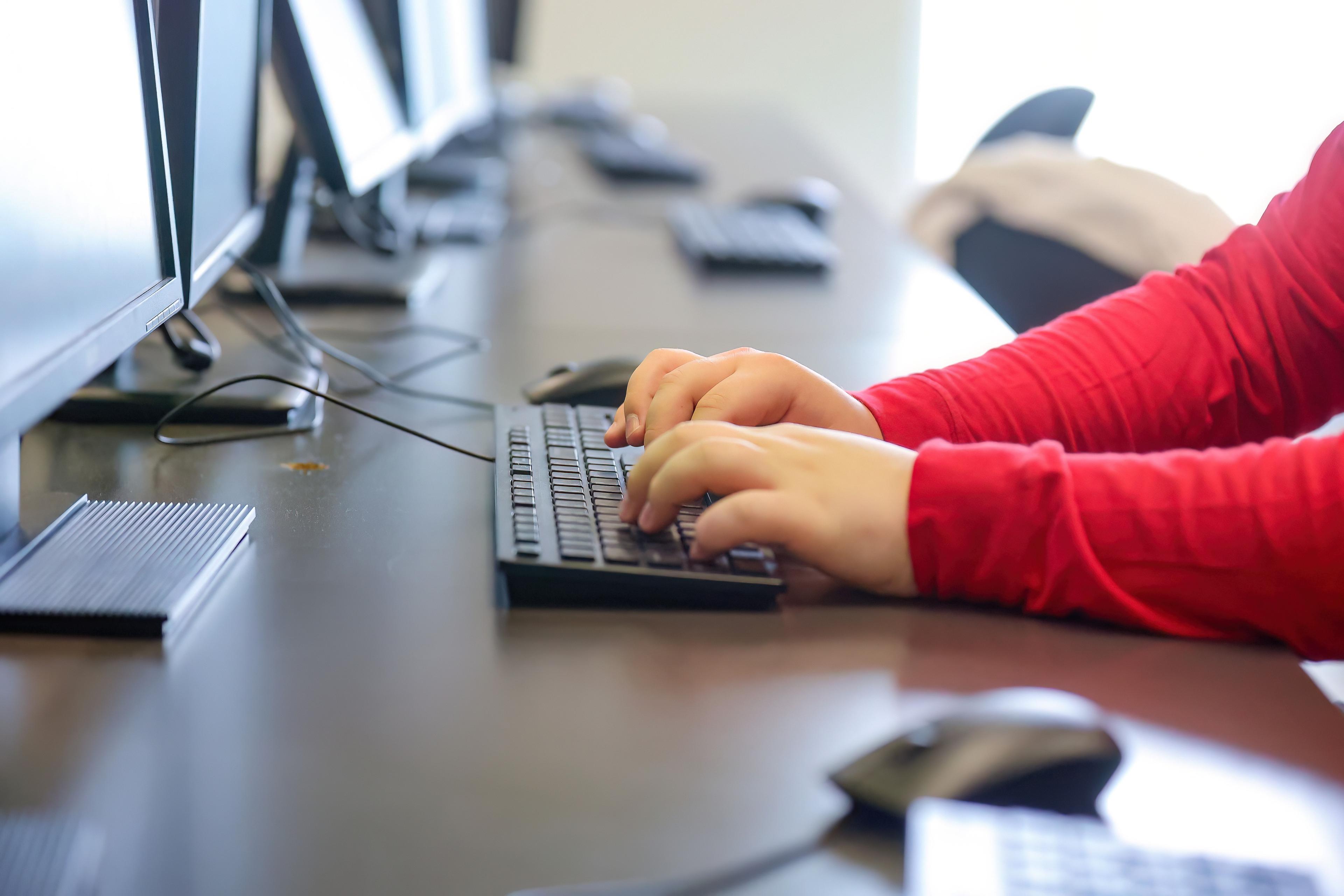 Person typing on keyboard