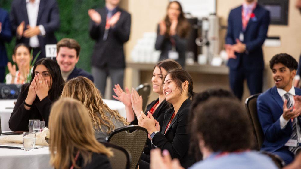 a dinner in lang plaza with many people laughing and clapping