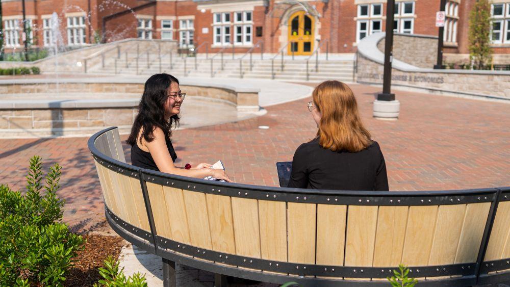 people sitting and talking in lang plaza