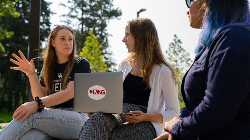 three people having a conversation