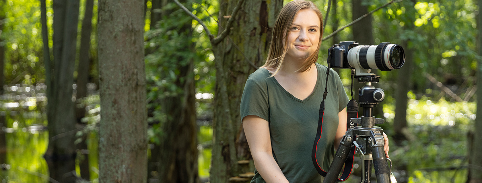 a student outside with a camera