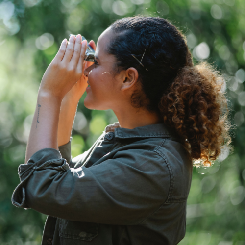 woman looking through binoculars