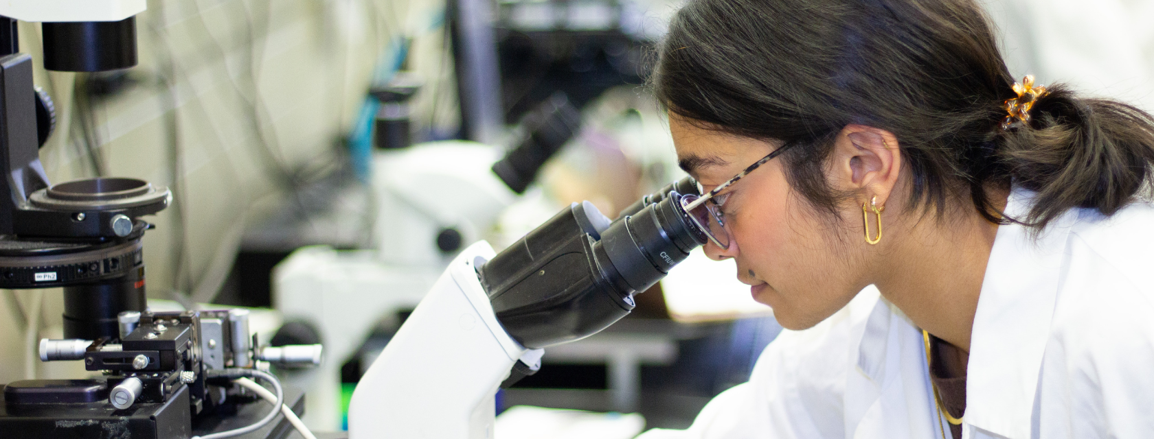 Student looking through microscope