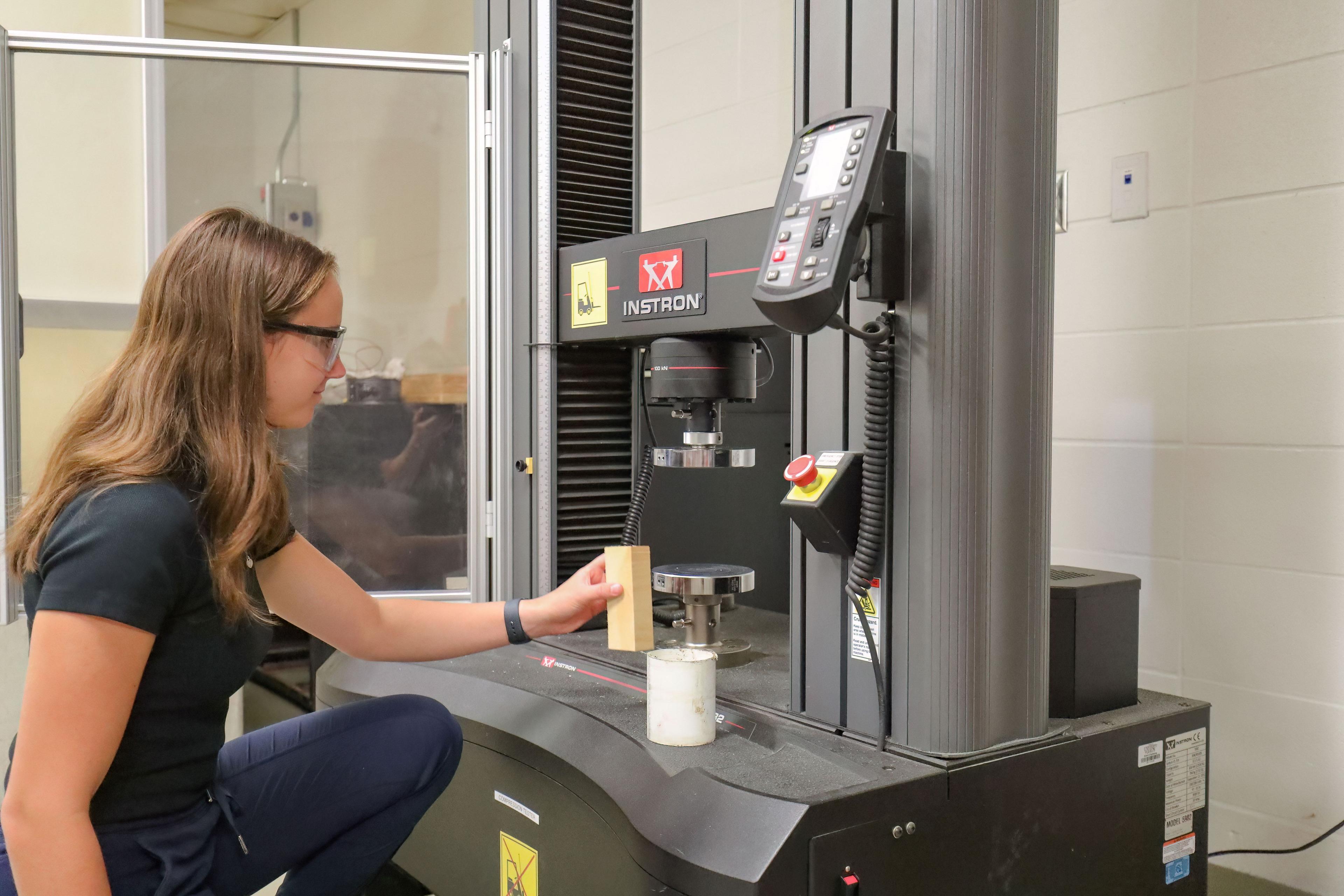 Student in the Engineering Lab using a testing system.