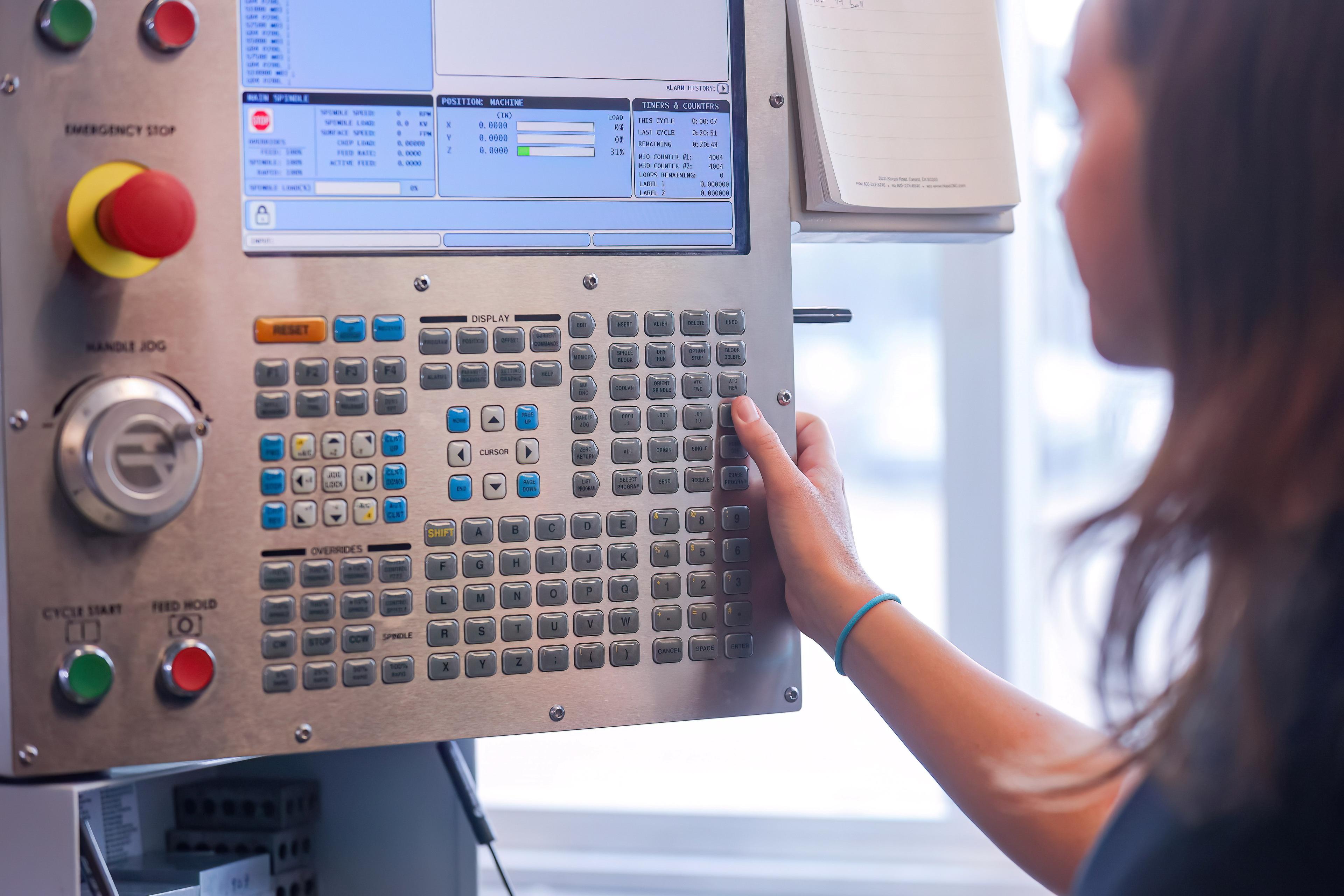 Student operating a machine in an Engineering lab.