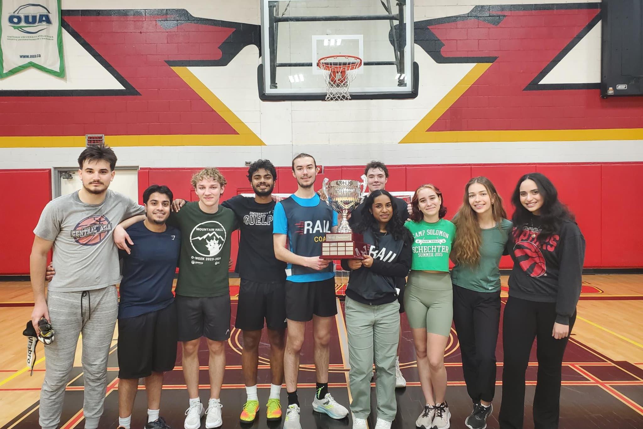 Students holding the residence cup
