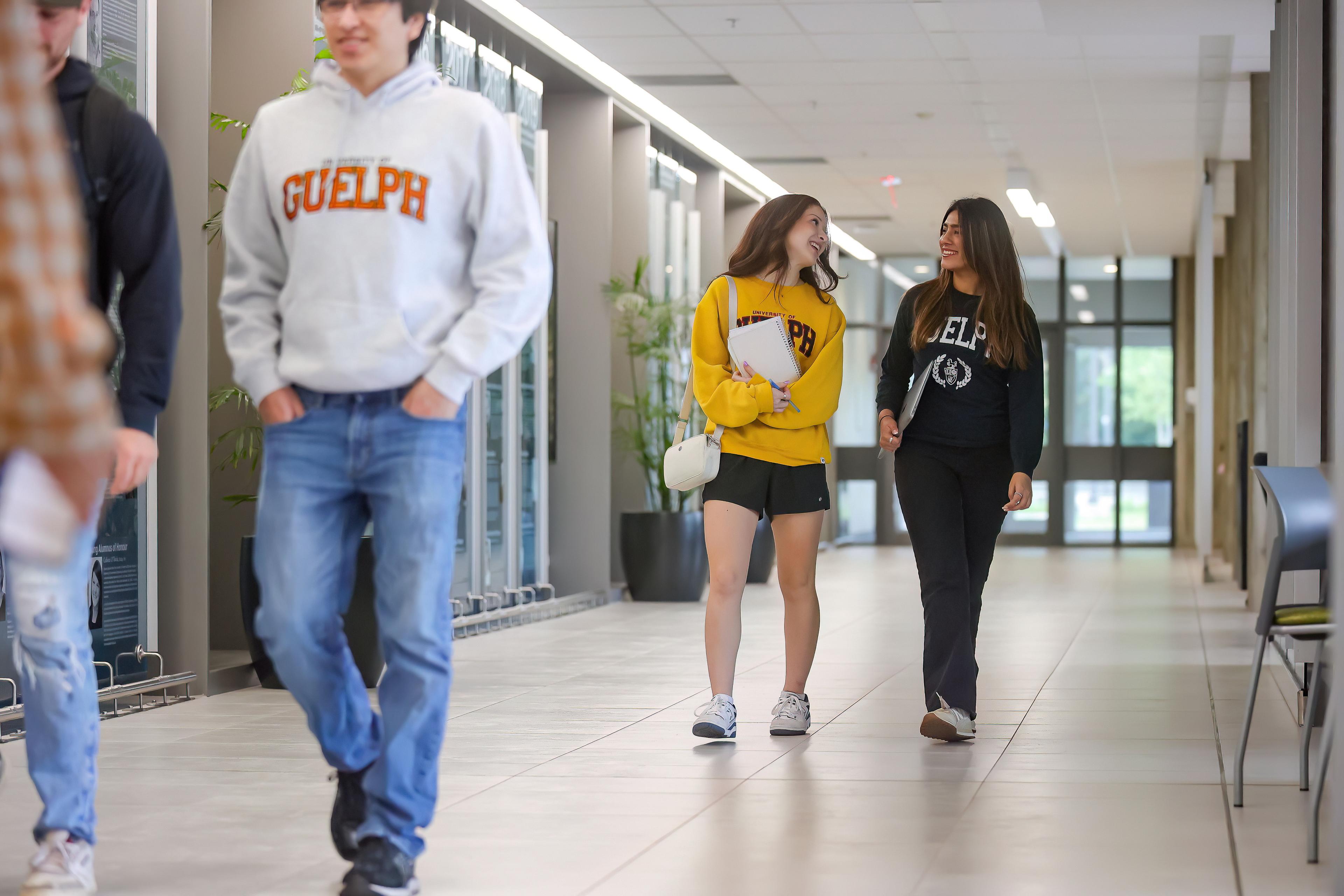 Two students walking down the hallway in Thornborough building.