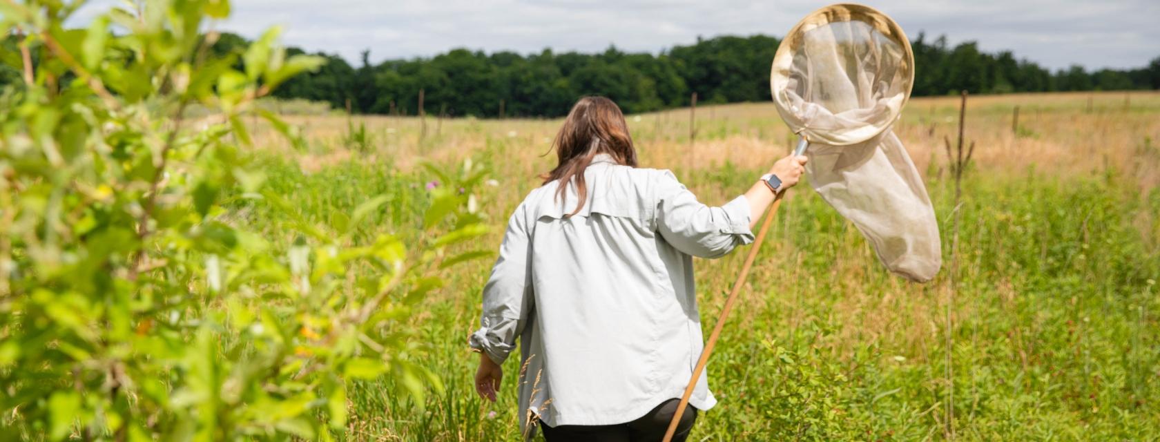 Student with bug net