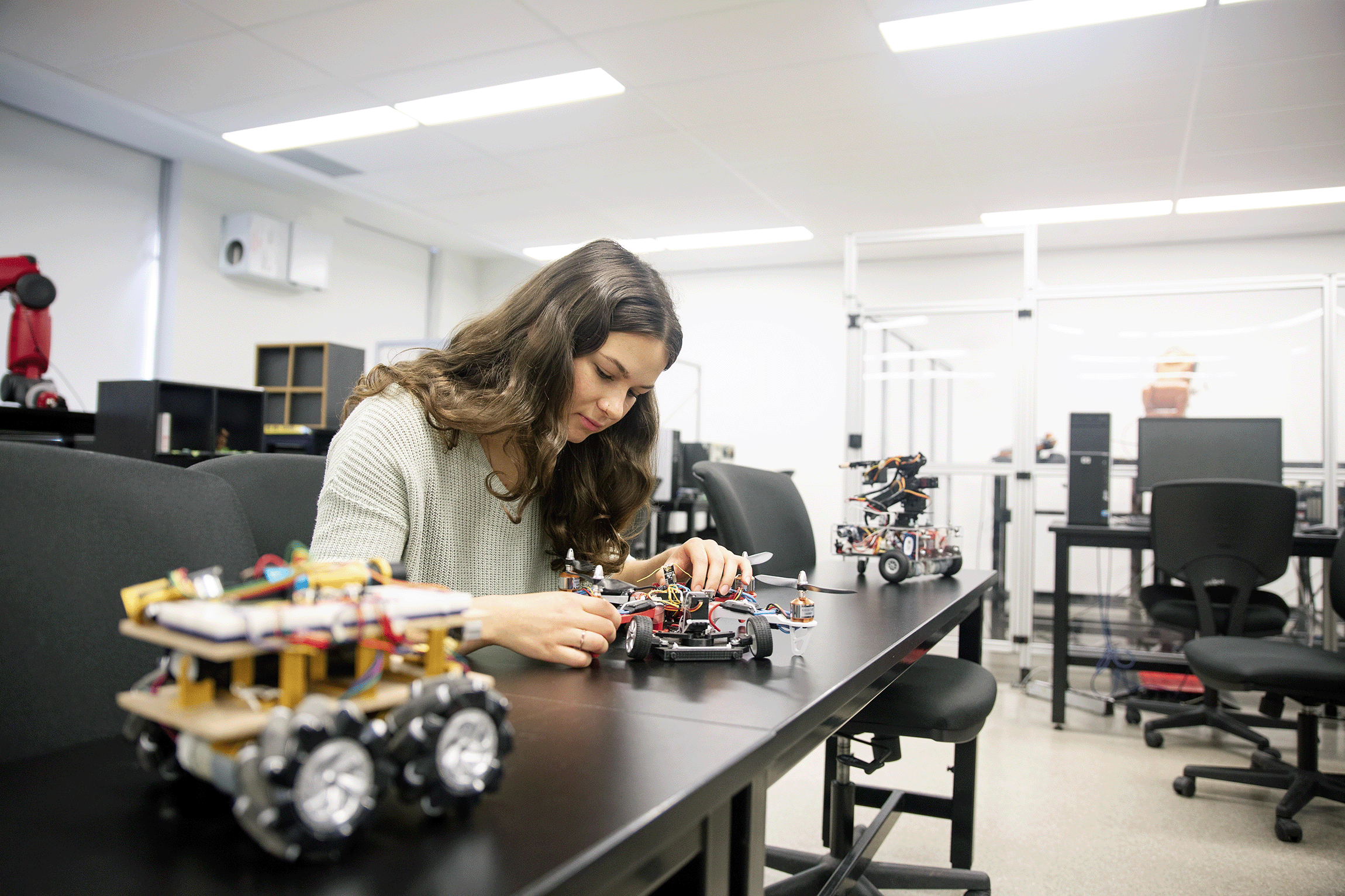 female student working on a small robot