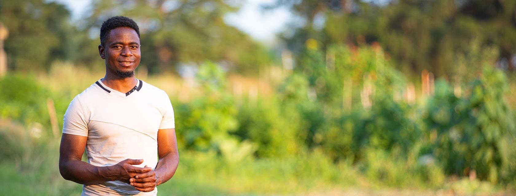 student in a field in the sunlight