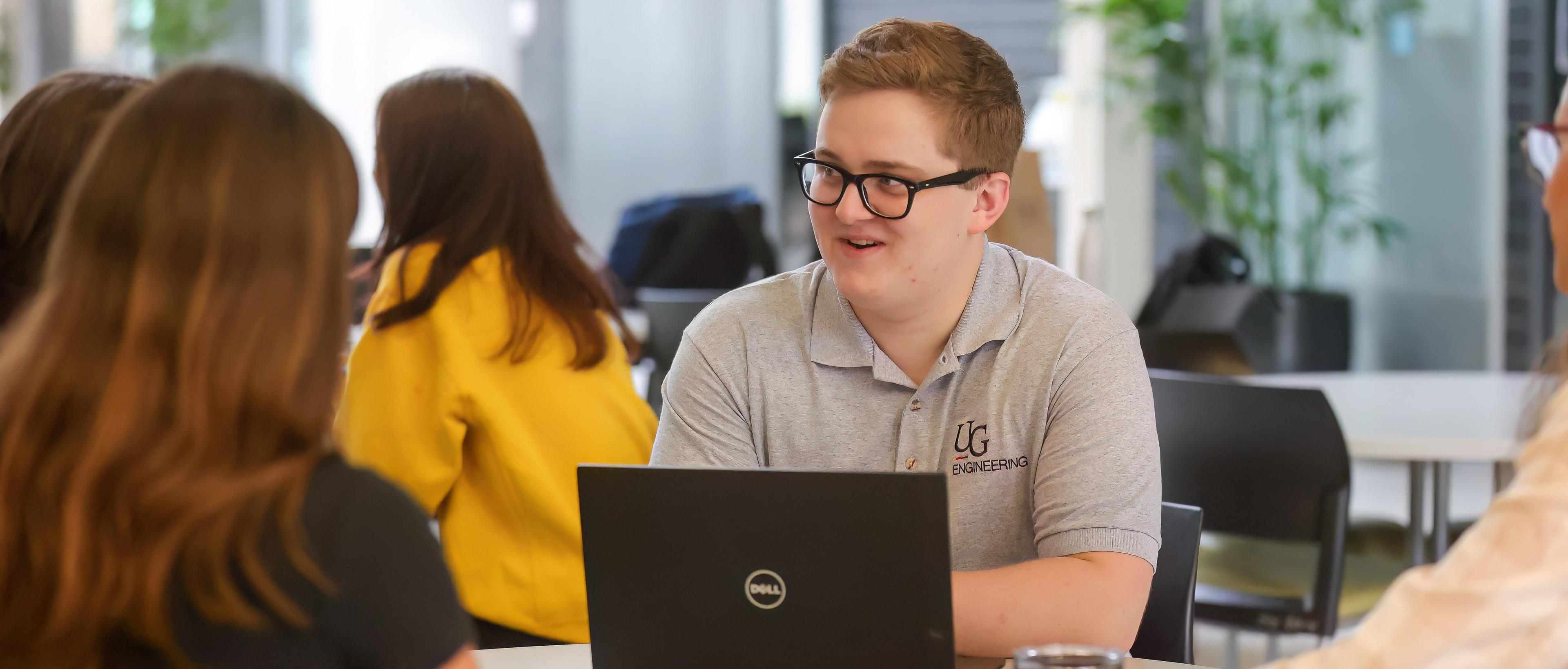 Group of students chatting in the Thornbrough Atrium.