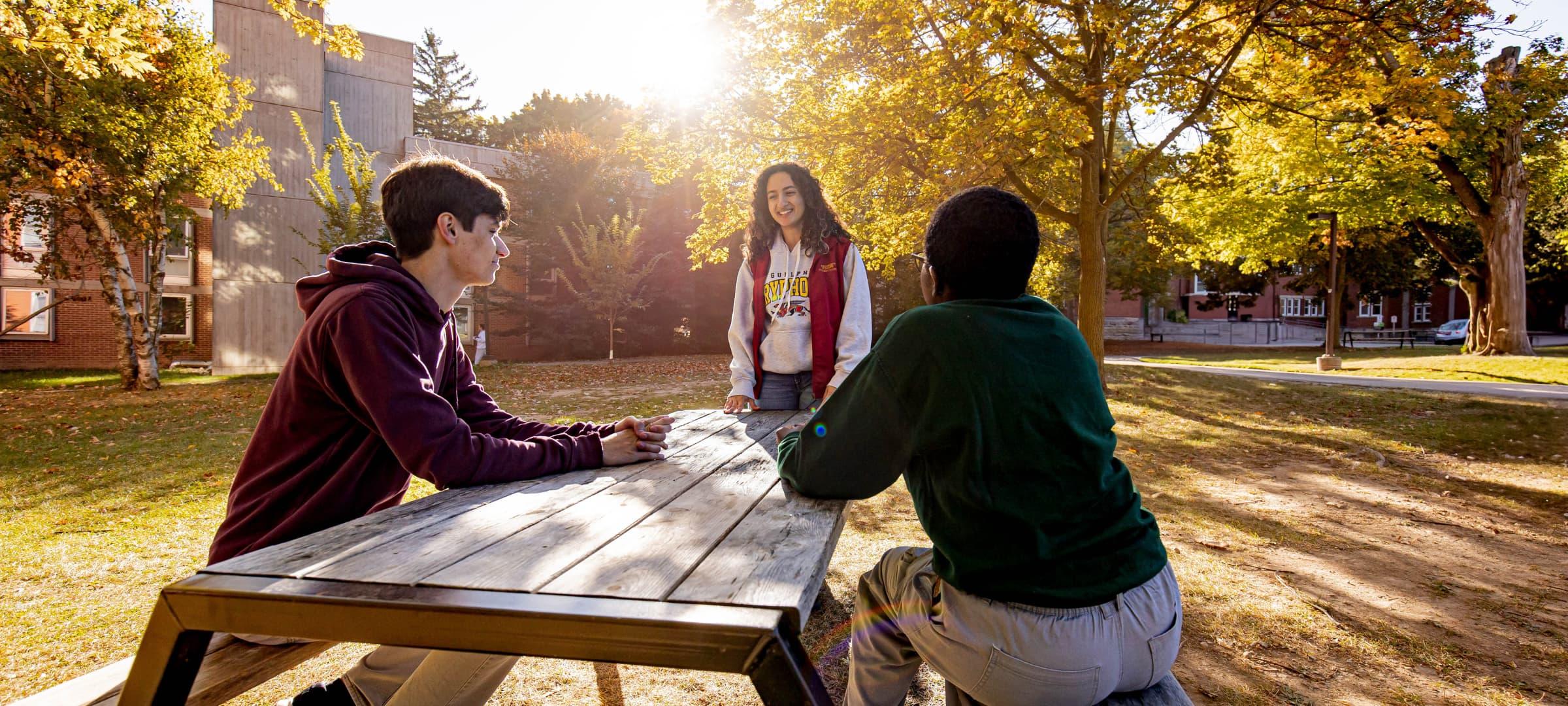 Two students and an RLS memebr talking outside North Residence 